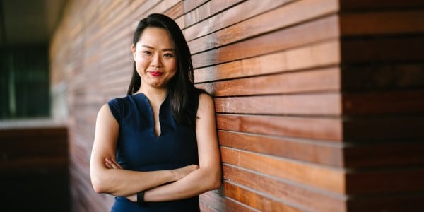 benefits of time management - professional woman standing against wall