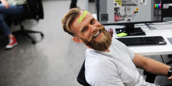 importance of time management - man smiling with sticky note on head that says be happy